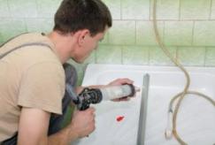 one of our Sammamish plumbers is sealing a bathtub